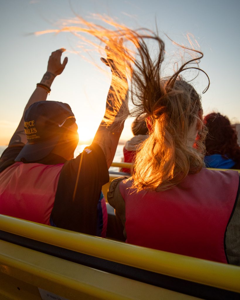 zodiac passenger raising hands
