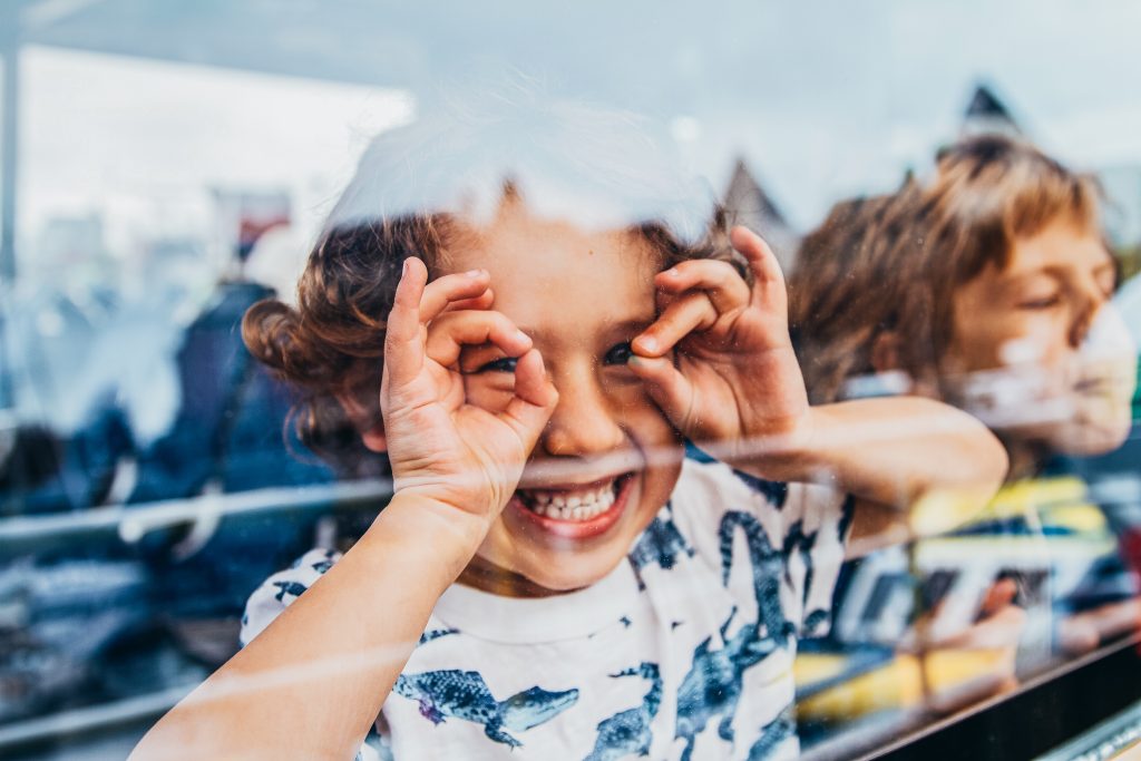 Kid smiling through window